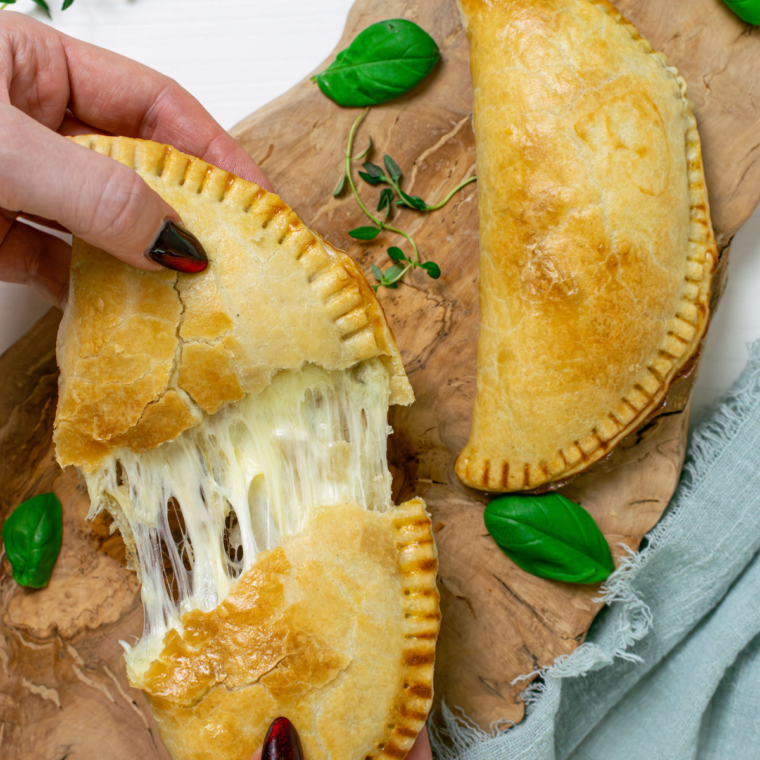 "Close-up of Air Fryer Cheese and Onion Pasty filled with melted cheese and caramelized onions."