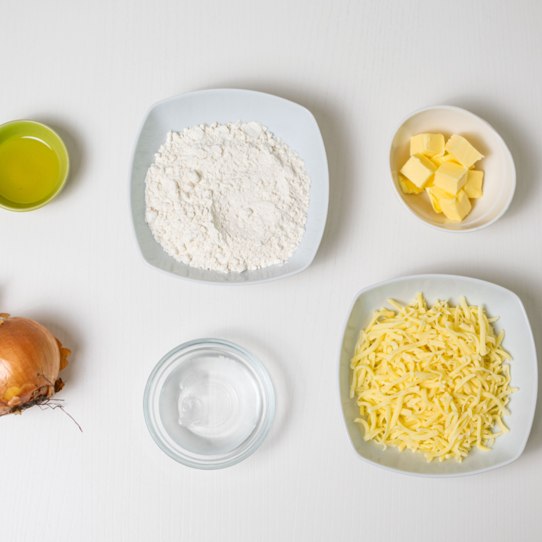 Ingredients needed for Air Fryer Cheese and Onion Pasty on kitchen table.