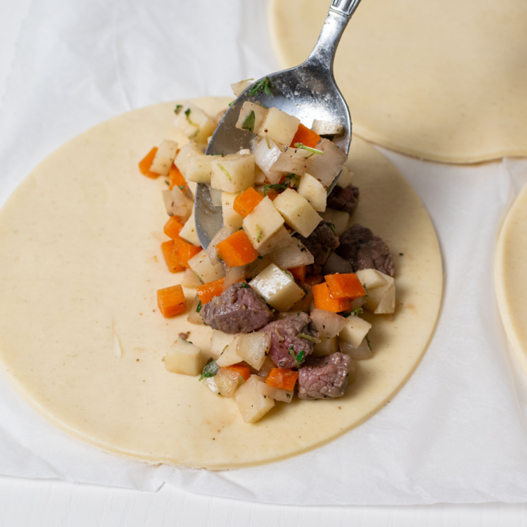 Adding a meat and vegetable filling to the pastry for Cornish Pasties.