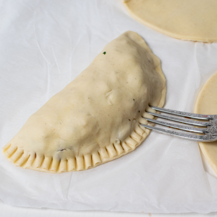 Sealing the edges of the Cornish Pastry before air frying.