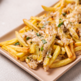 Golden fries topped with gooey melted cheese and chunks of seasoned crab meat, served fresh from the air fryer.