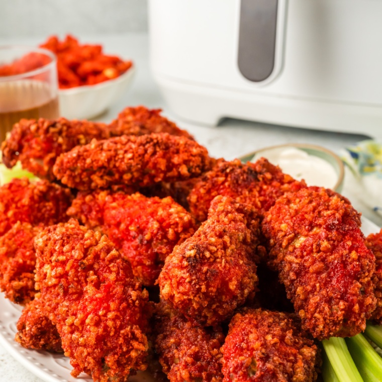 Air fryer Flamin' Hot Cheetos chicken wings served with a side of ranch and celery