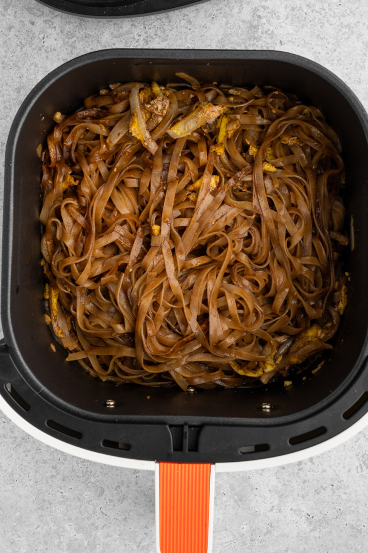 Toss noodles into the air fryer basket.