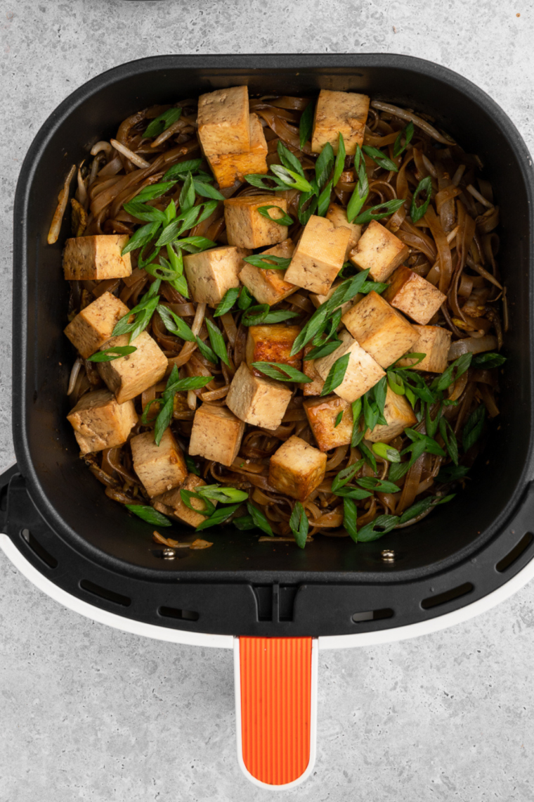 Close-up of Air Fryer Pad Thai on a plate with colorful veggies and savory sauce.