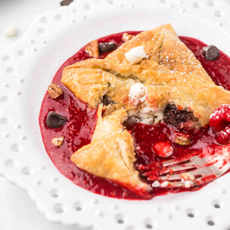"Golden Air Fryer Raspberry Chocolate Puffs with a gooey chocolate center and raspberry filling, dusted with powdered sugar."