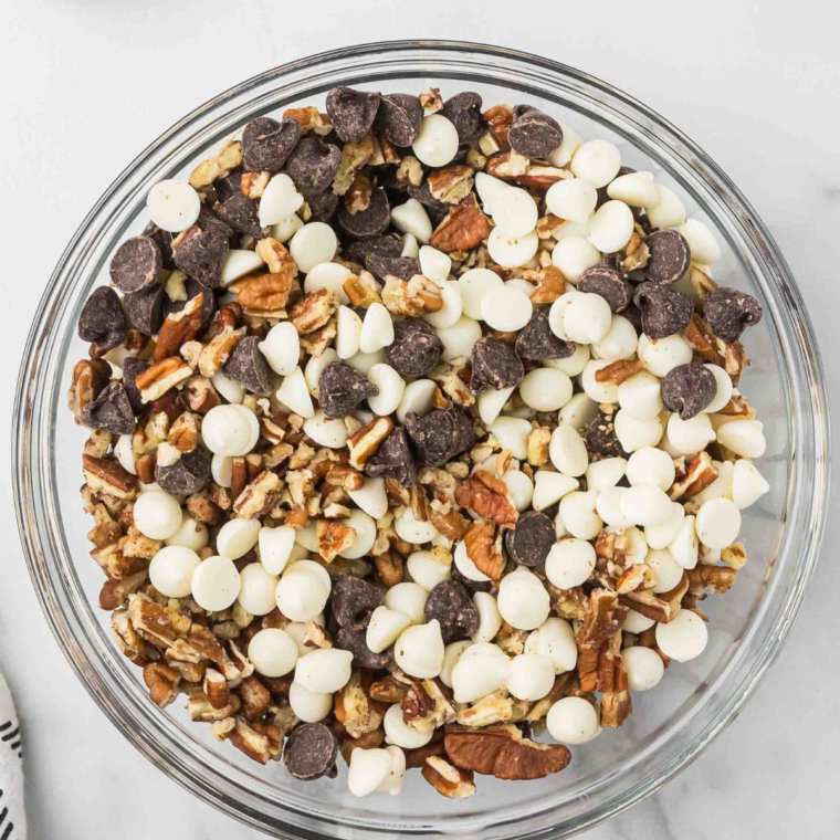 "Milk chocolate chips, white baking chips, and chopped pecans mixed together in a bowl for the filling."