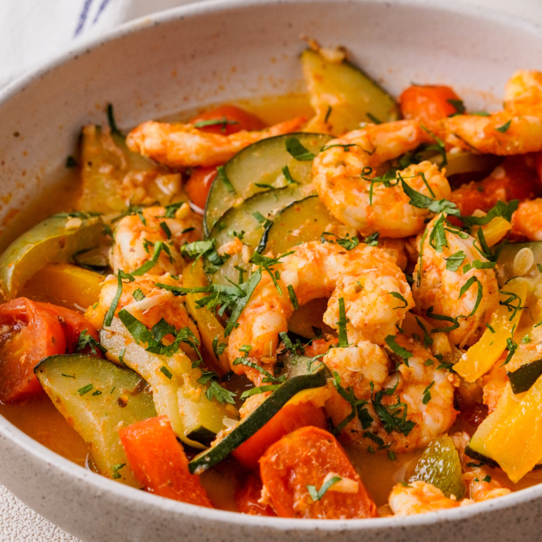 Close-up of cooked shrimp and vegetables in a foil packet from the air fryer