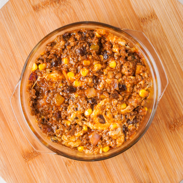 Mixing all of the toppings together in the casserole dish.