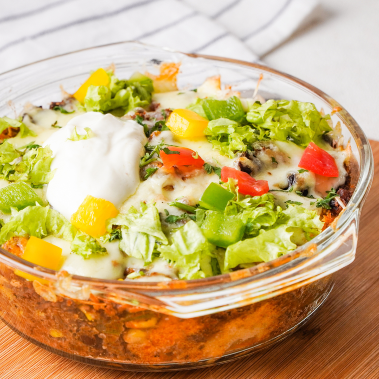 Air Fryer Taco Fiesta Bubble Up Casserole with golden-brown bubbly biscuit pieces topped with melted cheese and fresh cilantro.