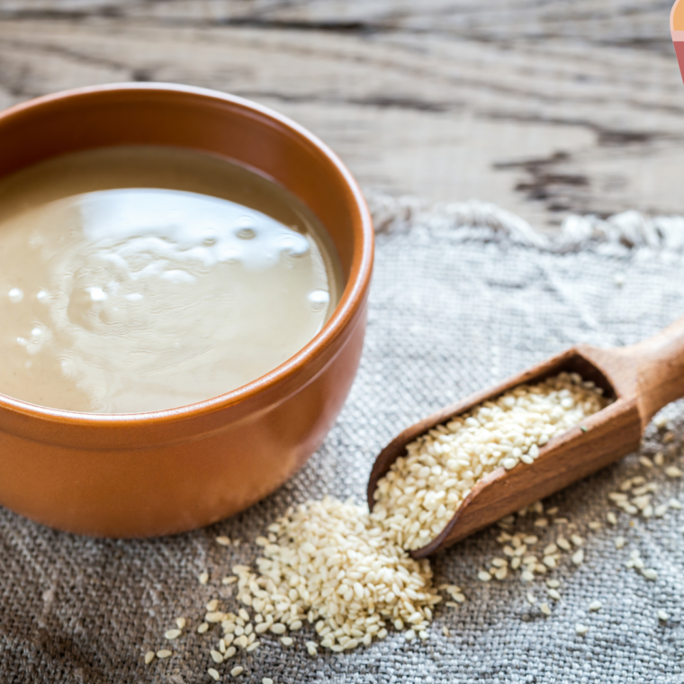 "Bowl of creamy Almond Butter Greek Yogurt Dip surrounded by fresh fruit and crackers."