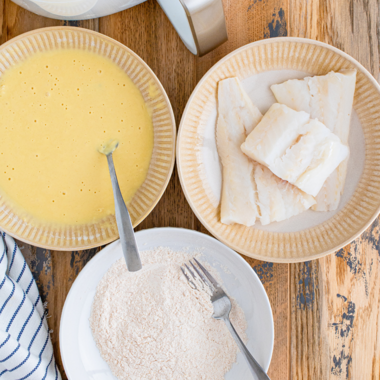 Mix the Wet Ingredients: A bowl with a beaten egg and club soda being whisked into a frothy, bubbly mixture.