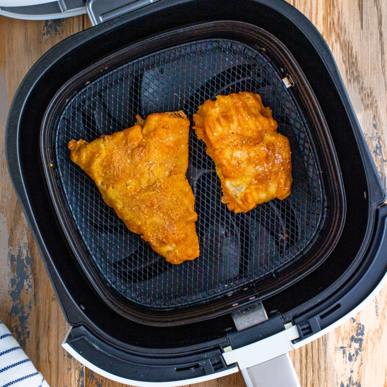 Coat the Fish: A fish fillet being dipped into a bowl of batter, fully coated with excess batter dripping off.