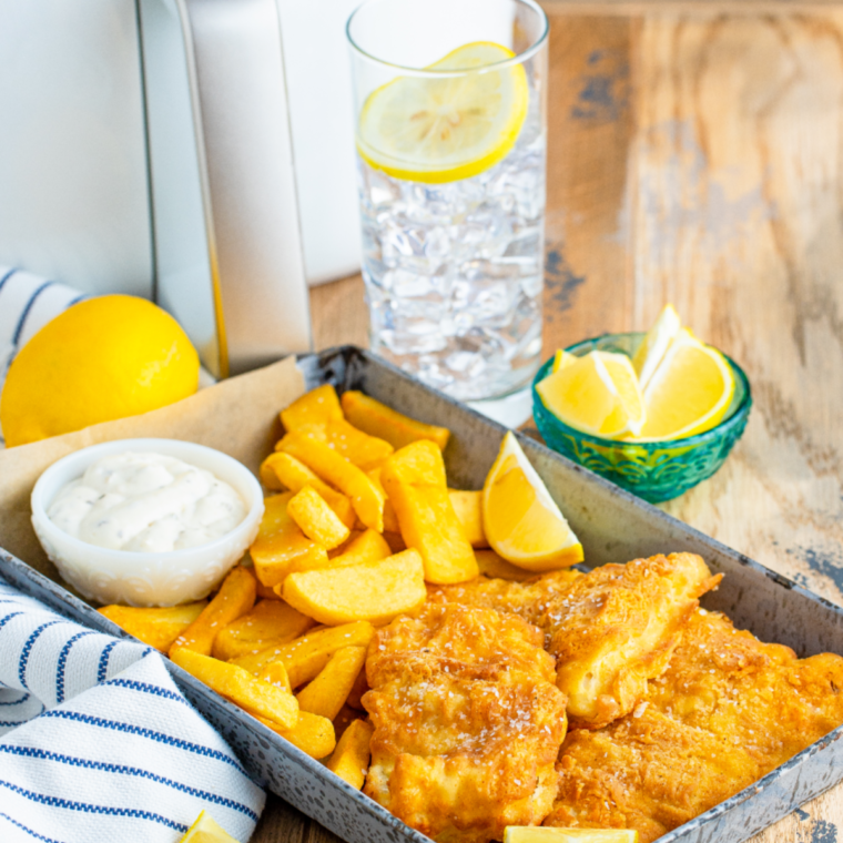 "Golden, crispy Arthur Treacher’s Fish Batter Copycat Recipe served with tartar sauce and a side of fries."