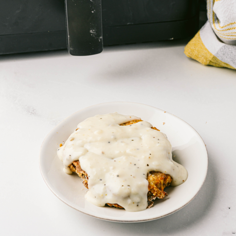 Plate of crispy, golden country fried chicken, served with mashed potatoes and gravy, inspired by Texas Roadhouse.