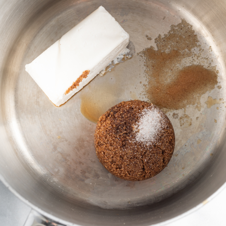 "Melting butter, brown sugar, salt, and vanilla in a pot while whisking in vinegar and baking soda for caramel sauce."