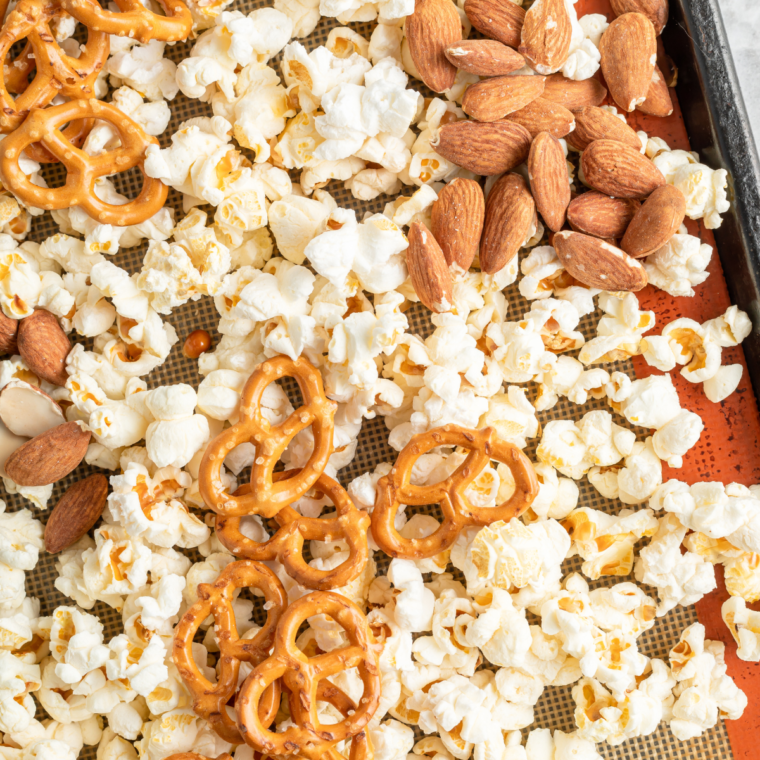 "Coated popcorn mixture in an air fryer basket, ready to air fry at 250°F with occasional stirring."