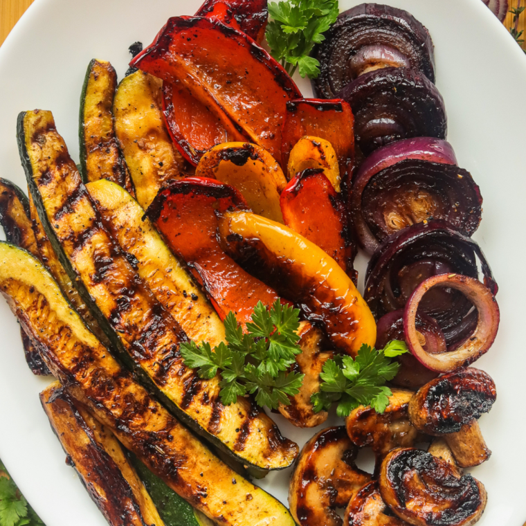 Close-up of perfectly caramelized balsamic vegetables on a Blackstone griddle."