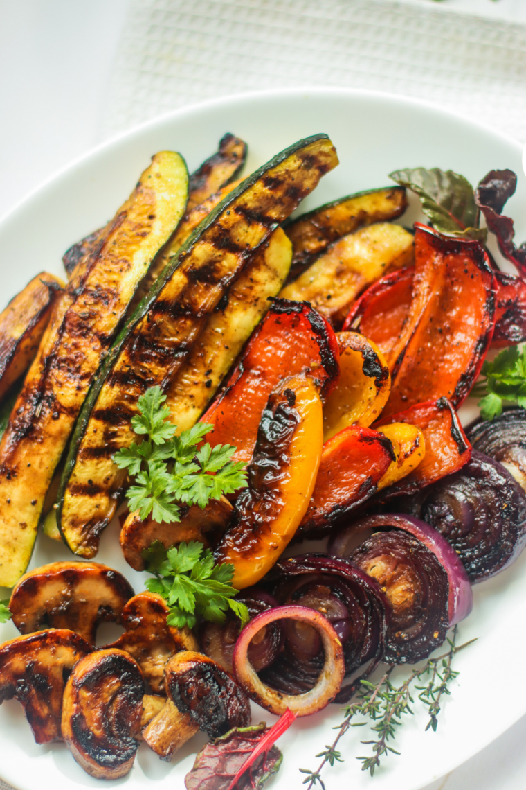 Fresh zucchini, bell peppers, and onions sautéing on the Blackstone griddle with balsamic vinegar.