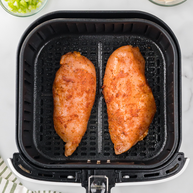 Placed seasoned chicken breast into the air fryer basket.