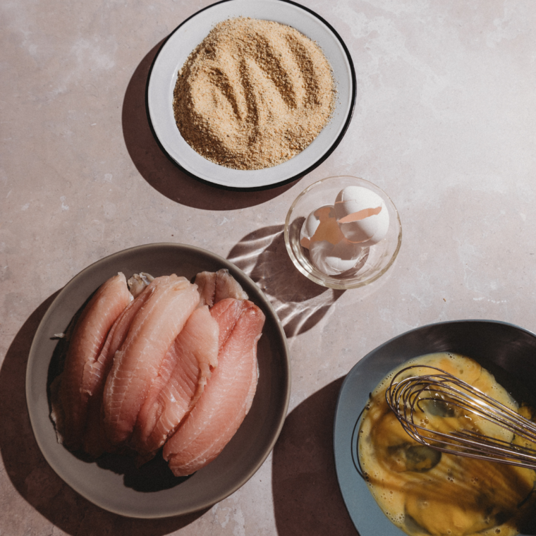 Preparing the tilapia with the seasoning mix on the side.