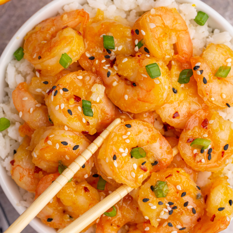 "Copycat P.F. Chang’s Dynamite Shrimp served crispy with a creamy, spicy sauce and garnished with green onions."