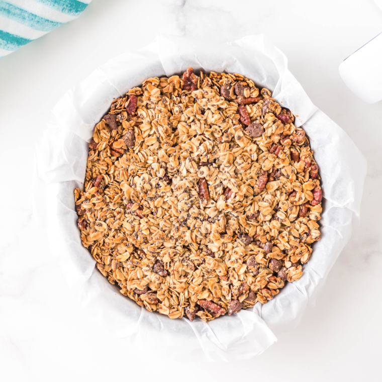 Close-up of crispy, golden granola clusters with nuts and seeds.