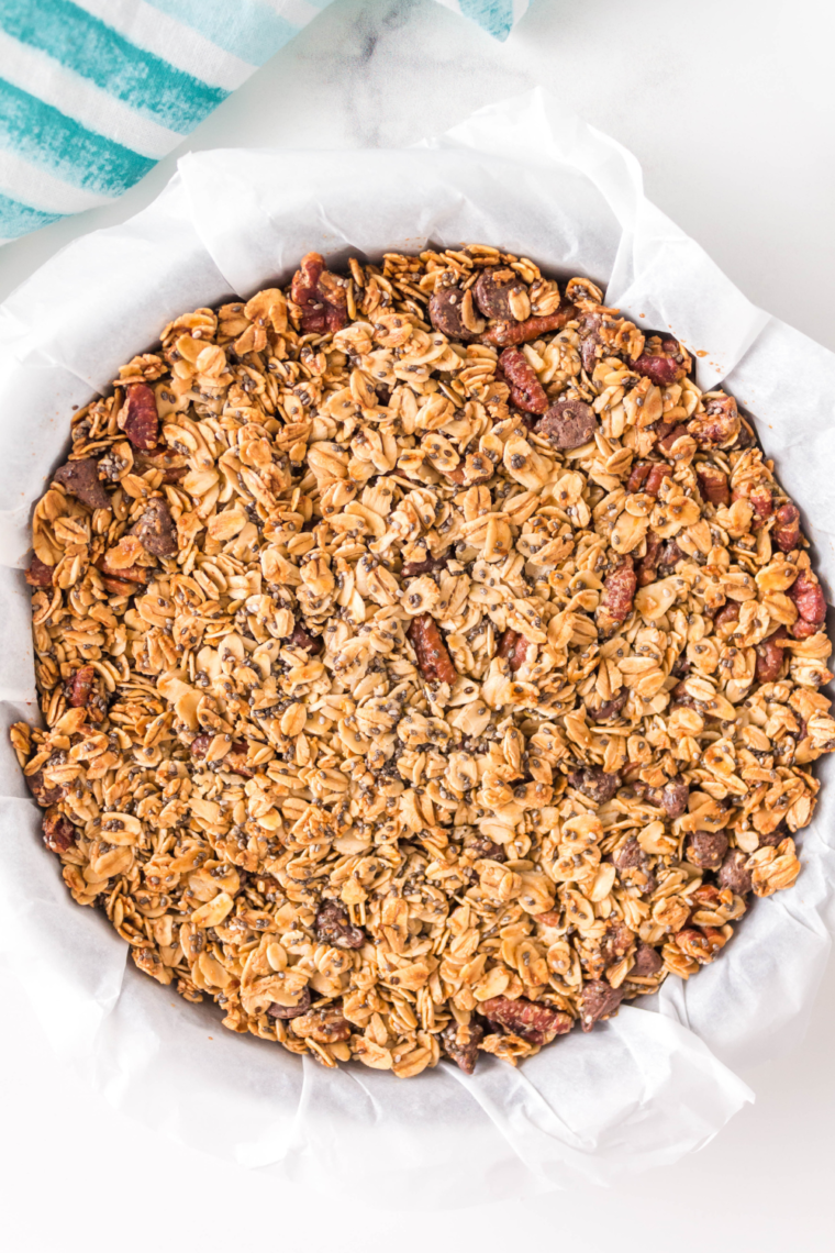 Granola cooling on a baking sheet, getting crunchy for storage.