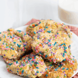 Copycat Publix sugar cookies topped with rainbow nonpareils on a wire cooling rack