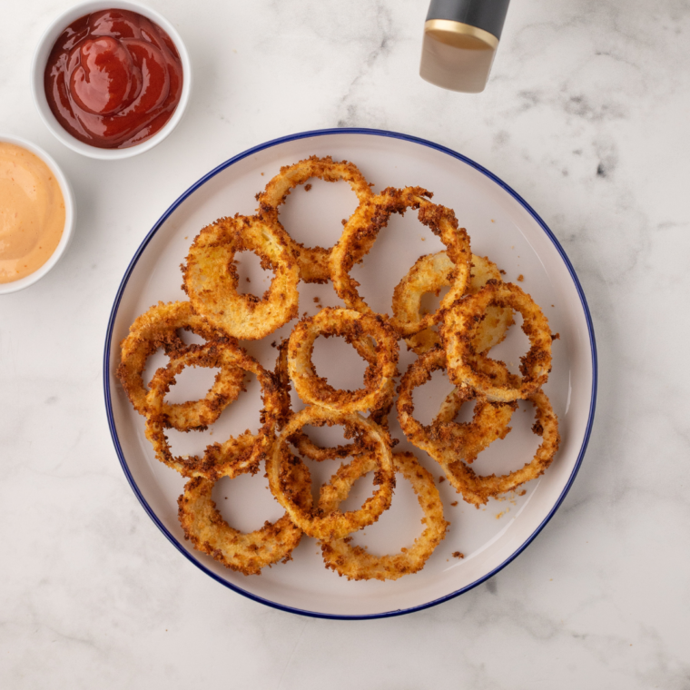 A batch of crispy homemade onion rings styled like Sonic's, golden brown and perfectly crunchy, served as a side dish.