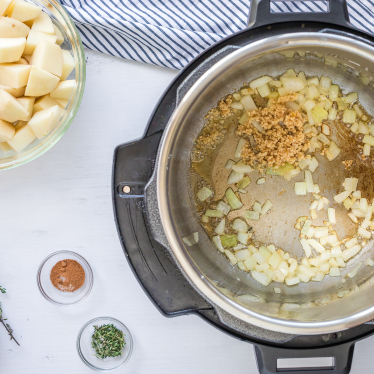 Adding the onions and garlic to the saucepan, saute until tender.