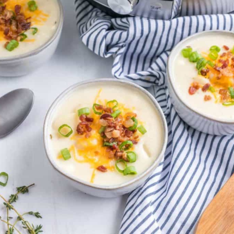 Bowl of Eat N Park Potato Soup, creamy and hearty with chunks of tender potatoes, garnished with green onions.