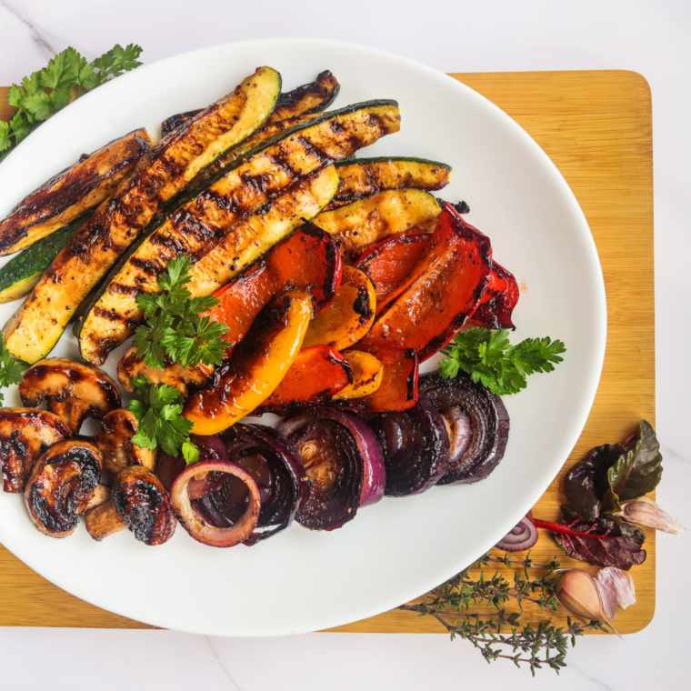 Colorful balsamic-glazed vegetables sizzling on a Blackstone griddle.