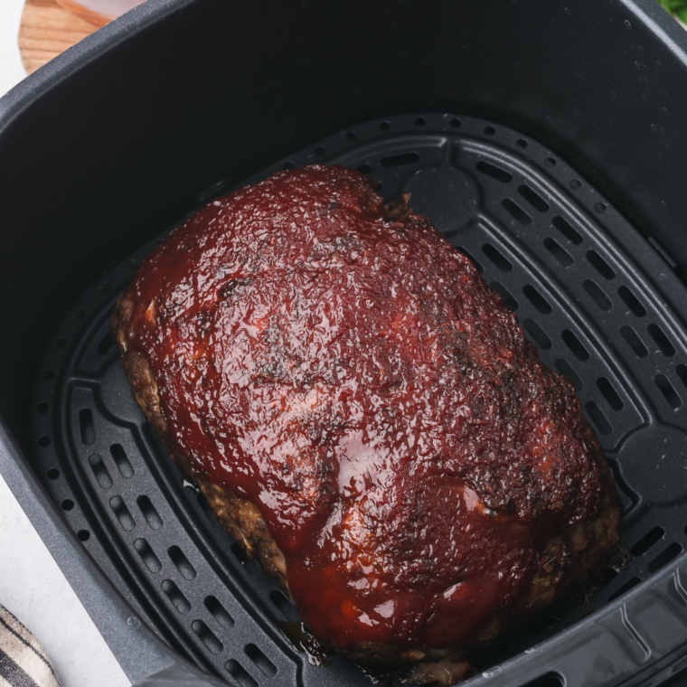 Golden Corral-style meatloaf cooked in an air fryer basket, ready to serve"