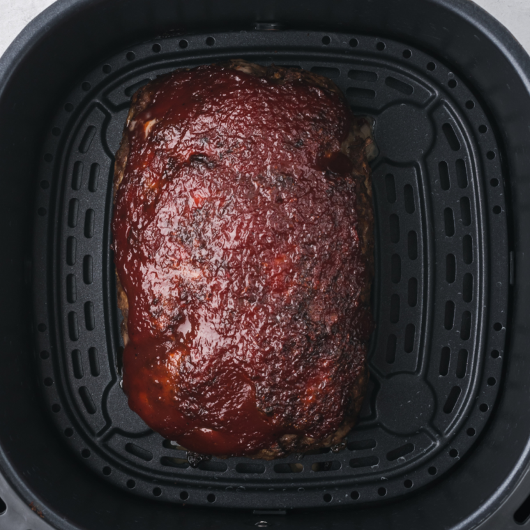 "Golden Corral-style meatloaf on a serving plate with ketchup glaze"