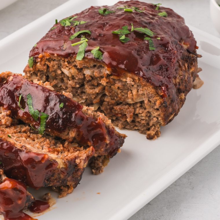 "Plate of Golden Corral-inspired meatloaf with a savory glaze and side vegetables"