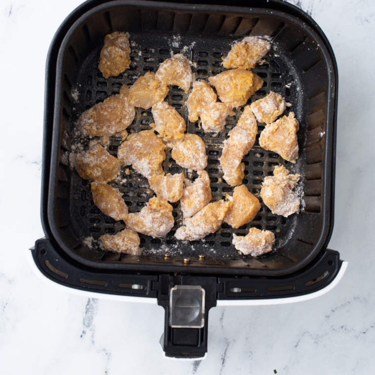 "Air fryer basket with crispy Longhorn Spicy Chicken Bites"