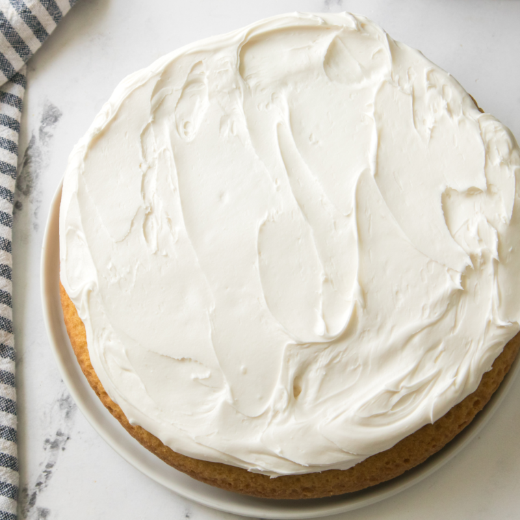 Maggiano’s Butter Cake on a plate with a fork, showcasing its light and fluffy texture.