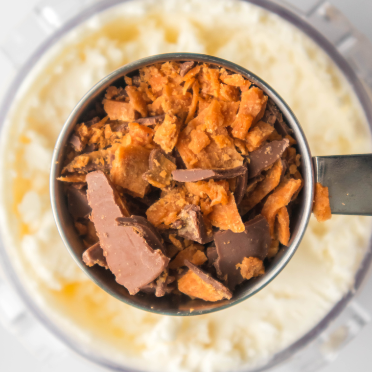 "Stirring in Butterfinger baking bits into Ninja Creami ice cream mixture"