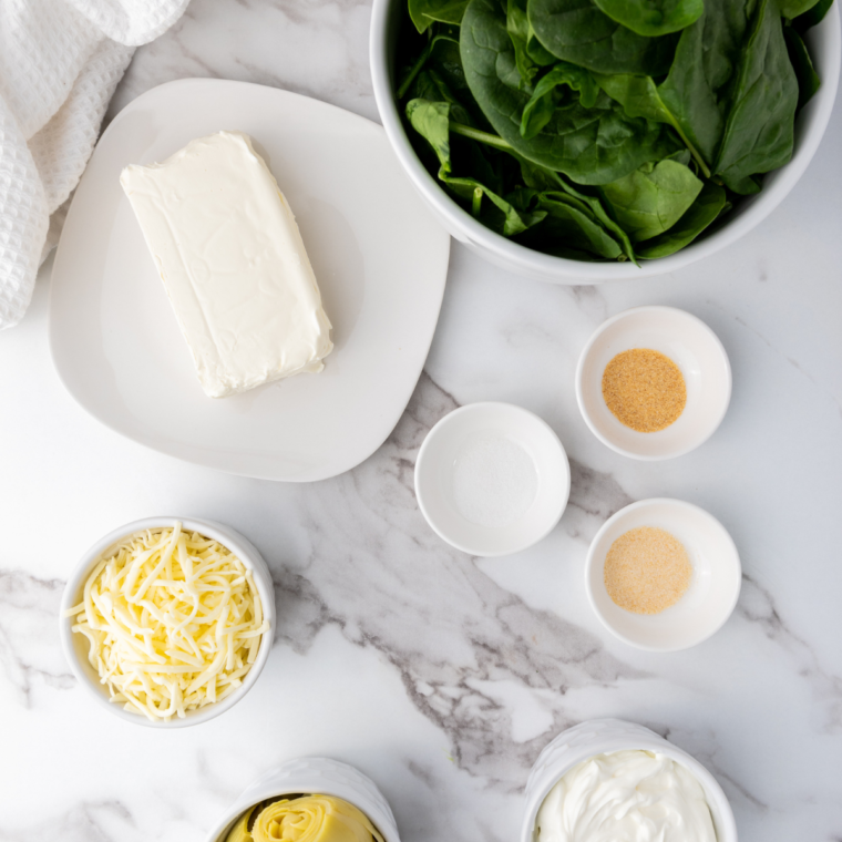 Ingredients needed for Ninja Foodi Possible Cooker Pro Spinach Artichoke Dip on kitchen table.