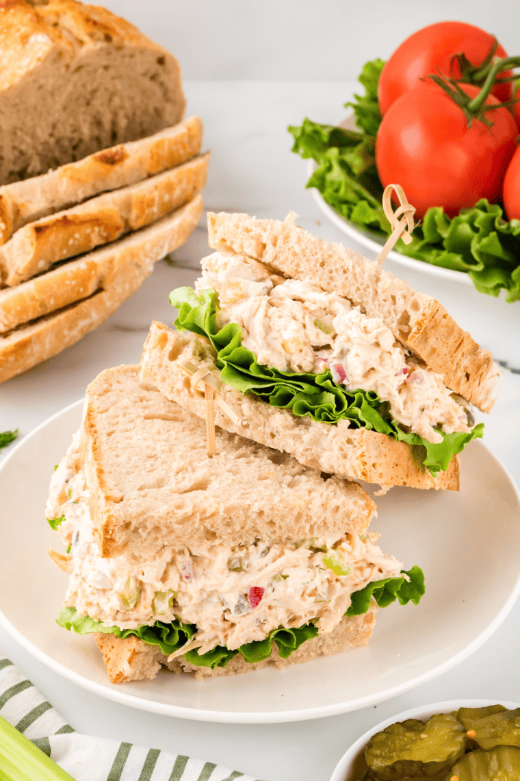 Sandwich with chicken salad and lettuce sliced in half