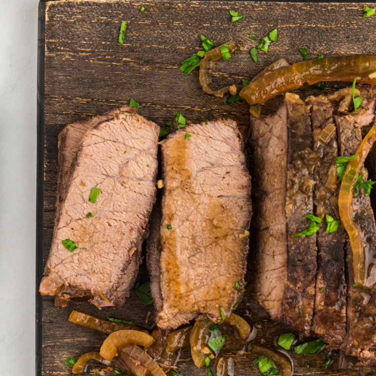 "Tender slow-cooked flank steak served with savory sauce."