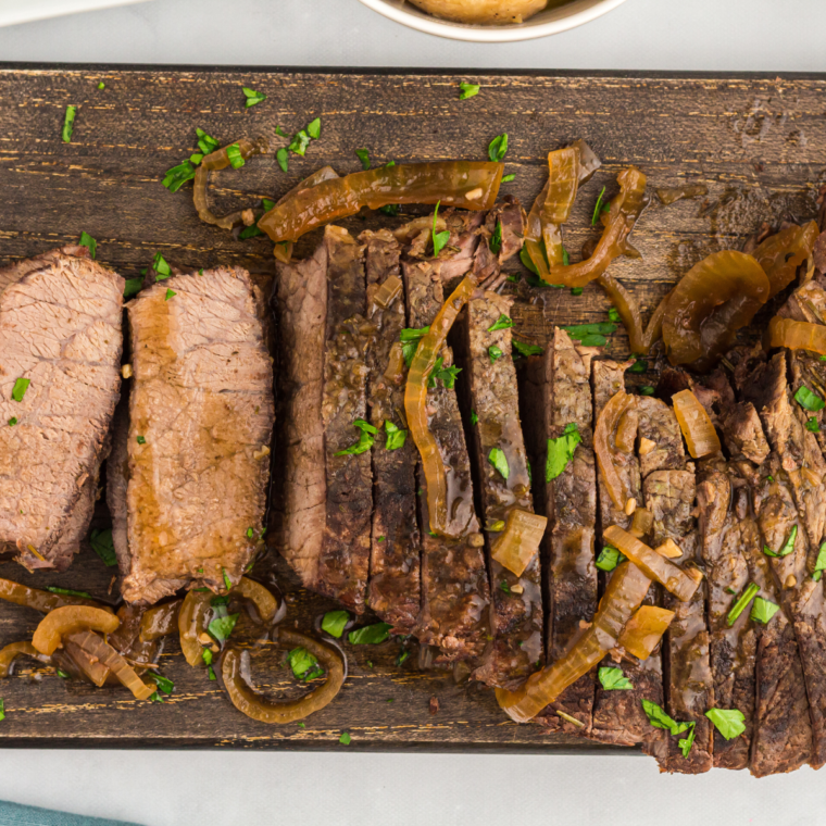 Top view of sliced flank steak on a cutting board