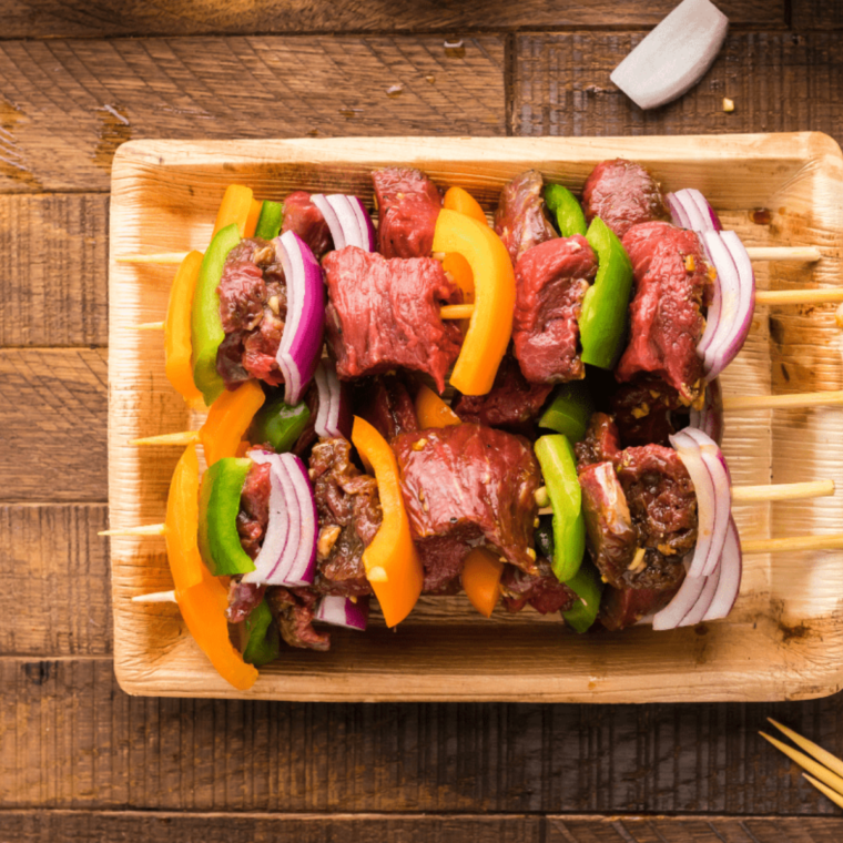 A plate of threaded Steak Kabob Texas Roadhouse Recipe with tender steak, bell peppers, onions, mushrooms, and zucchini, perfectly grilled and served.