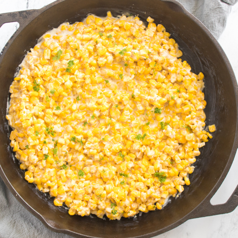 Texas Roadhouse Buttered Corn served alongside grilled steak and sides on a restaurant-style plate.