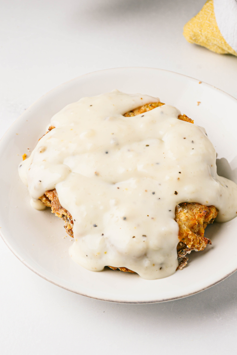 : Crispy and golden Air Fryer Texas Roadhouse Country Fried Chicken served with a side of mashed potatoes.