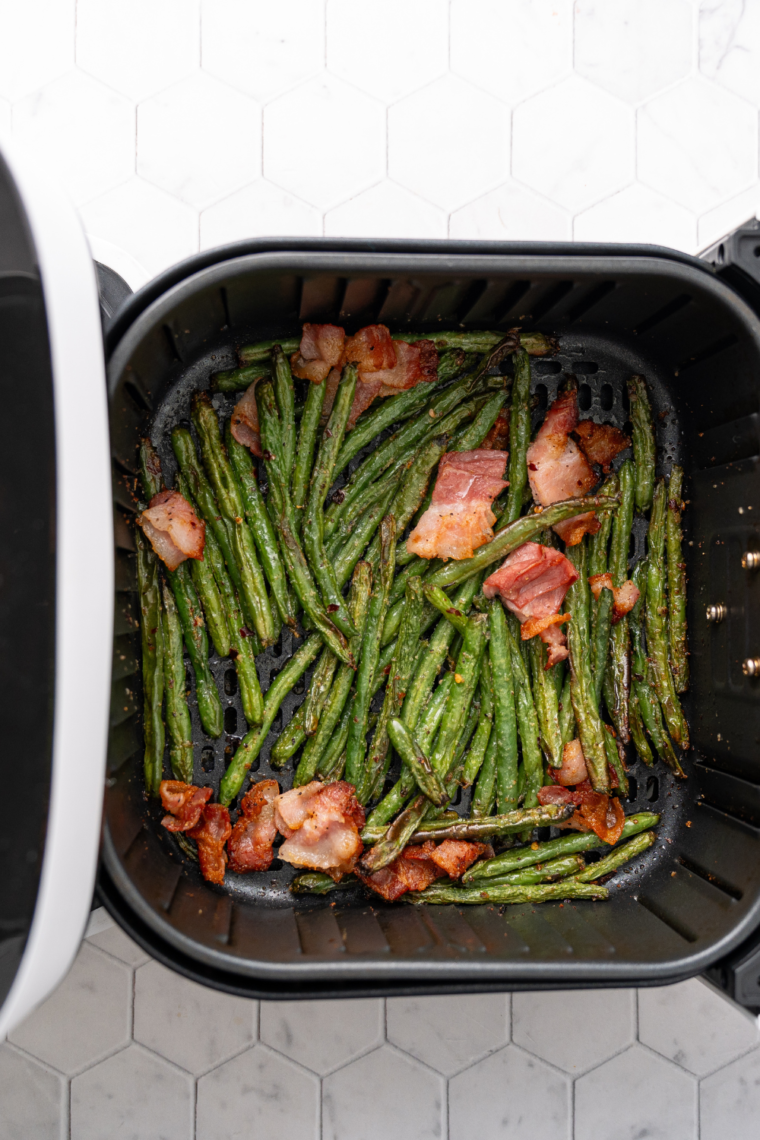 Cooked Texas Roadhouse Green Beans in the air fryer basket.