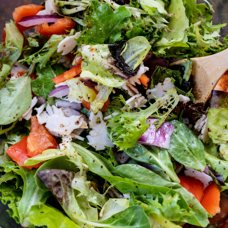 A jar of homemade Texas Roadhouse Sweet Italian Dressing, showcasing its golden color and fresh ingredients, ready to enhance any salad or meal.