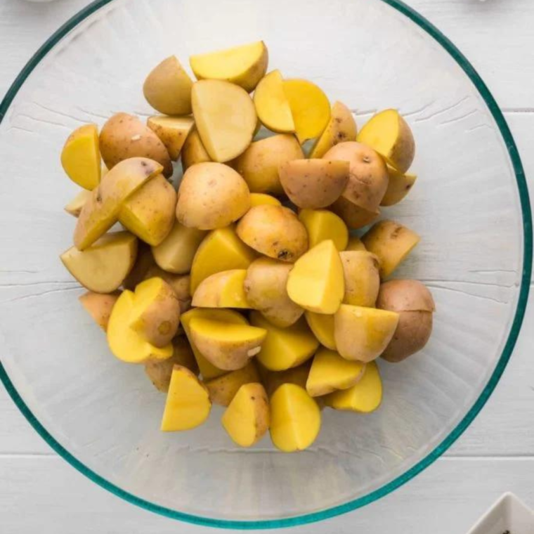 Step-by-step process of making Vesuvio Potatoes, with garlic, herbs, and white wine in the pan.