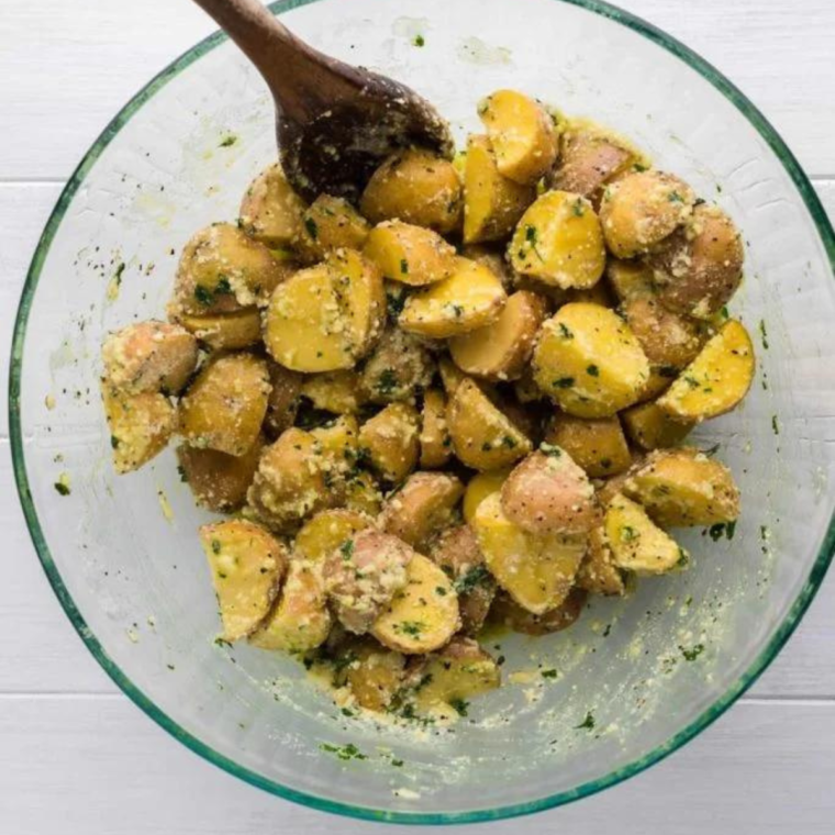 Mixing the potatoes with herbs.