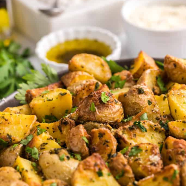 Golden, crispy Vesuvio Potatoes garnished with fresh herbs, ready to serve as a savory side dish.